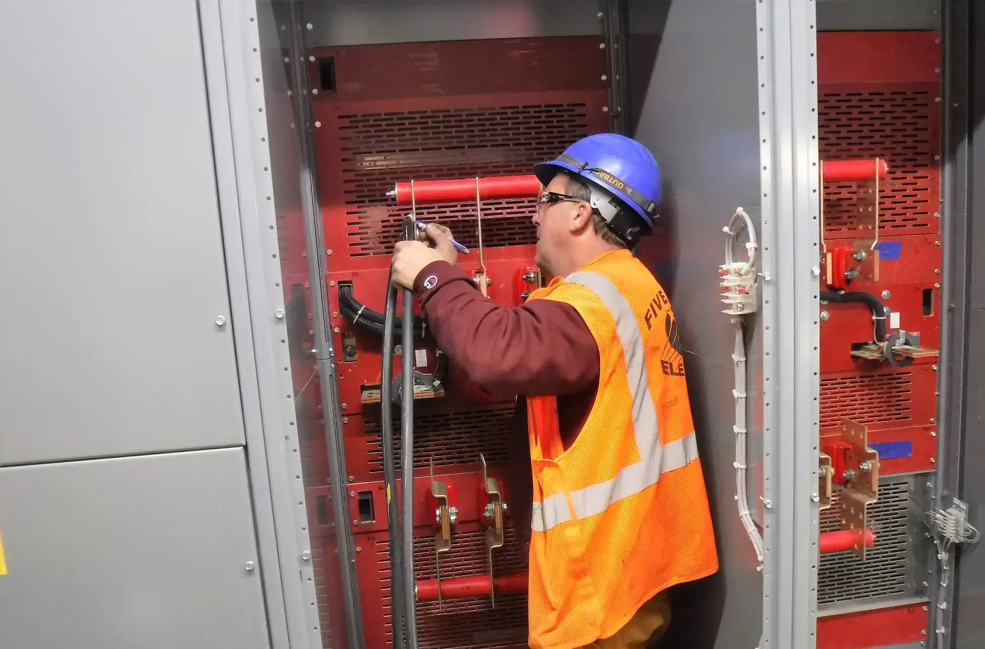 Electricista instalando tubería conduit en una sala de tableros